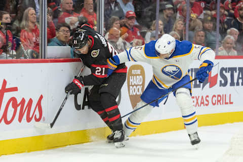 Oct 24, 2023; Ottawa, Ontario, CAN; Ottawa Senators right wing Mathieu Joseph (21) battles with Buffalo Sabres defenseman Erik Johnson (6) for control of the puck in the first period at the Canadian Tire Centre. Mandatory Credit: Marc DesRosiers-USA TODAY Sports