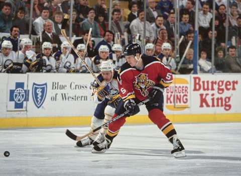 The Sabres bench and coaching staff looks on as Gord Murphy #5, Defenseman for the Florida Panthers checks #18 Wayne Presley, Right Wing for the Buffalo Sabres during their NHL Eastern Conference Northeast Division game on 18th February 1994 at the Buffalo Memorial Auditorium in Buffalo, New York, United States. The Sabres won the game 4 – 1. (Photo by Rick Stewart/Allsport/Getty Images)