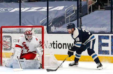 Mar 25, 2021; Columbus, Ohio, USA; Columbus Blue Jackets center Boone Jenner (38) moves in for a shot against Carolina Hurricanes goalie Alex Nedeljkovic (39) during the first period at Nationwide Arena. Mandatory Credit: Russell LaBounty-USA TODAY Sports