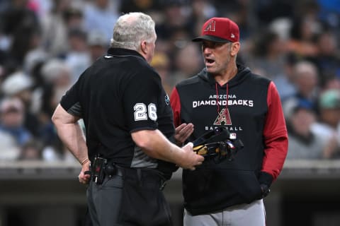 Jul 15, 2022; San Diego, California, USA; Arizona Diamondbacks manager Torey Lovullo (right) talks to home plate umpire Bill Miller (26) during the third inning against the San Diego Padres at Petco Park. Mandatory Credit: Orlando Ramirez-USA TODAY Sports