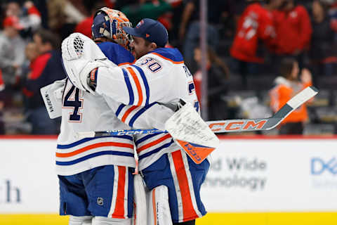 Nov 24, 2023; Washington, District of Columbia, USA; Edmonton Oilers goaltender Stuart Skinner (74) celebrates with Oilers goaltender Calvin Pickard (30) after their game against the Washington Capitals at Capital One Arena. Mandatory Credit: Geoff Burke-USA TODAY Sports