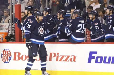 NHL Power Rankings: Winnipeg Jets right wing Blake Wheeler (26) celebrates with teammates after scoring against Boston Bruins goalie Tuukka Rask (not pictured) during the first period at MTS Centre. Mandatory Credit: Bruce Fedyck-USA TODAY Sports