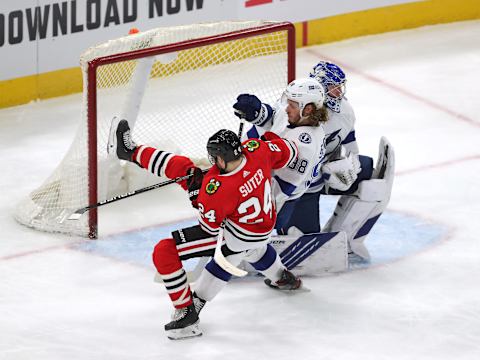 Mar 7, 2021; Chicago, Illinois, USA; Chicago Blackhawks center Pius Suter (24) is checked by Tampa Bay Lightning defenseman Mikhail Sergachev (98) during the third period at the United Center. Mandatory Credit: Dennis Wierzbicki-USA TODAY Sports