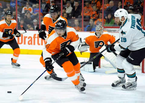 Nov 19, 2015; Philadelphia, PA, USA; Philadelphia Flyers right wing Matt Read (24) picks up loose puck away from San Jose Sharks center Joe Thornton (19) during the first period at Wells Fargo Center. Mandatory Credit: Eric Hartline-USA TODAY Sports