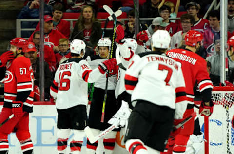 RALEIGH, NC – NOVEMBER 2: Miles Wood #44 of the New Jersey Devils celebrates with teammates after scoring a goal during an NHL game against the Carolina Hurricanes on November 2, 2019 at PNC Arena in Raleigh, North Carolina. (Photo by Gregg Forwerck/NHLI via Getty Images)