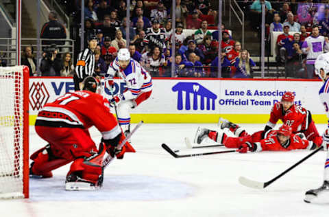 RALEIGH, NC – MARCH 23: Shayne Gostisbehere #41 and Jesperi Kotkaniemi #82 of the Carolina Hurricanes attempt to stop the puck during the third period of the game against the New York Rangers at PNC Arena on March 23, 2023, in Raleigh, North Carolina. Rangers win over Hurricanes 2-1. (Photo by Jaylynn Nash/Getty Images)