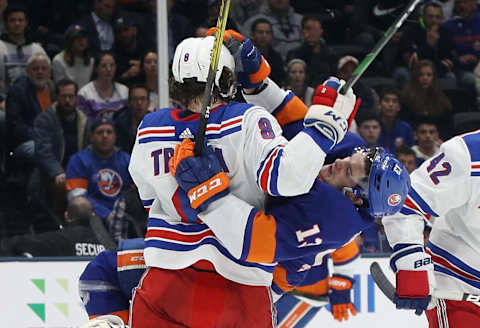 NEW YORK, NEW YORK – FEBRUARY 25: Jacob Trouba #8 of the New York Rangers checks Mathew Barzal #13 of the New York Islanders during the second period at NYCB Live’s Nassau Coliseum on February 25, 2020 in Uniondale, New York. (Photo by Bruce Bennett/Getty Images)