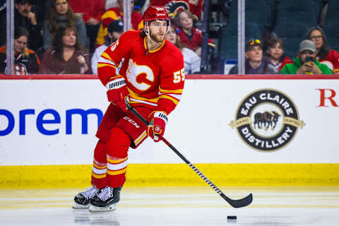 Apr 2, 2023; Calgary, Alberta, CAN; Calgary Flames defenseman Noah Hanifin (55) controls the puck against the Anaheim Ducks during the third period at Scotiabank Saddledome. Mandatory Credit: Sergei Belski-USA TODAY Sports