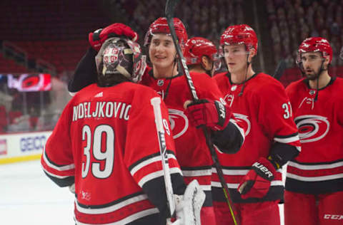 Feb 20, 2021; Raleigh, North Carolina, USA; Carolina Hurricanes goaltender Alex Nedeljkovic (39) is congratulated by center Martin Necas (88) after there win against the Tampa Bay Lightning at PNC Arena. Mandatory Credit: James Guillory-USA TODAY Sports