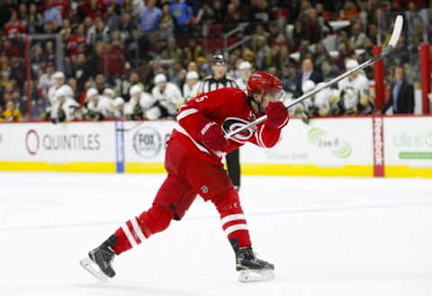 Feb 12, 2016; Raleigh, NC, USA; Carolina Hurricanes defensemen Noah Hanifin (5) takes a overtime shot against the Pittsburgh Penguins at PNC Arena. The Pittsburgh Penguins defeated the Carolina Hurricanes 2-1 in the shoot out. Mandatory Credit: James Guillory-USA TODAY Sports