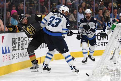 Ryan Carpenter of the Vegas Golden Knights battles for the puck with Dustin Byfuglien of the Winnipeg Jets during the second period in Game Four of the Western Conference Finals during the 2018 NHL Stanley Cup Playoffs.