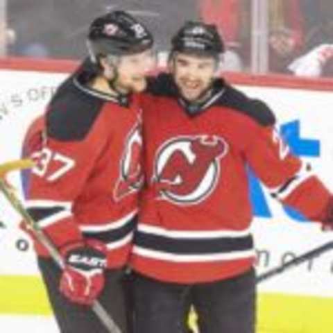 Apr 9, 2016; Newark, NJ, USA; New Jersey Devils right wing Kyle Palmieri (21) and Devils center Pavel Zacha (37) celebrate a goal by Palmieri against the Toronto Maple Leafs during the third period at Prudential Center. The Devils defeated the Maple Leafs 5-1. Mandatory Credit: Ed Mulholland-USA TODAY Sports