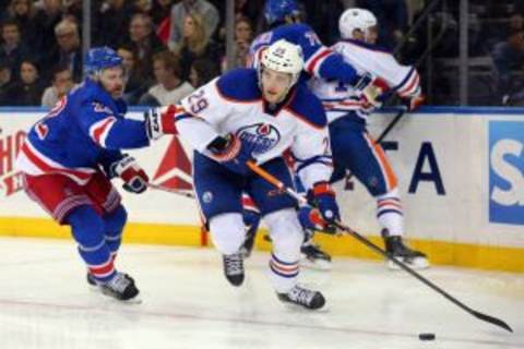 Dec 15, 2015; New York, NY, USA; Edmonton Oilers center Leon Draisaitl (29) controls the puck in front of New York Rangers defenseman Dan Boyle (22) during the third period at Madison Square Garden. The Rangers defeated the Oilers 4-2. Mandatory Credit: Brad Penner-USA TODAY Sports