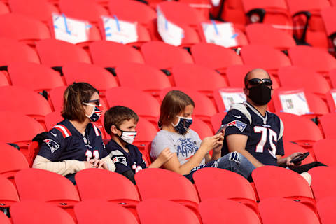 A group of New England Patriots fans sit in the stands before the game between the Patriots and the Kansas City Chiefs at Arrowhead Stadium. (Photo by Jamie Squire/Getty Images)