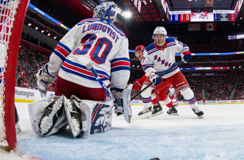 DETROIT, MI – MARCH 07: Tyler Bertuzzi #59 of the Detroit Red Wings scores a second period goal past goaltender Henrik Lundqvist #30 of the New York Rangers as Tony DeAngelo #77 of the Rangers looks for the rebound during an NHL game at Little Caesars Arena on March 7, 2019 in Detroit, Michigan. (Photo by Dave Reginek/NHLI via Getty Images)