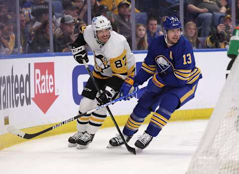 Mar 23, 2022; Buffalo, New York, USA; Pittsburgh Penguins center Sidney Crosby (87) and Buffalo Sabres defenseman Mark Pysyk (13) looks for the puck during the first period at KeyBank Center. Mandatory Credit: Timothy T. Ludwig-USA TODAY Sports