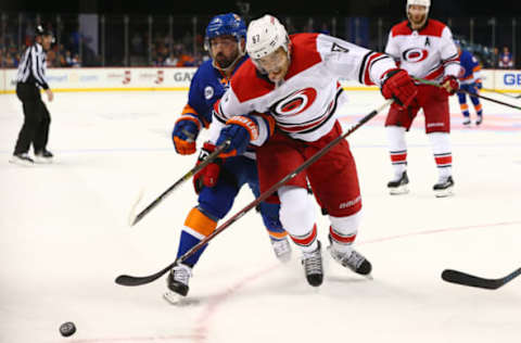 NEW YORK, NEW YORK – APRIL 26: Cal Clutterbuck #15 of the New York Islanders battles against Trevor van Riemsdyk #57 of the Carolina Hurricanes during Game One of the Eastern Conference Second Round during the 2019 NHL Stanley Cup Playoffs at Barclays Center on April 26, 2019 in New York City. (Photo by Mike Stobe/NHLI via Getty Images)