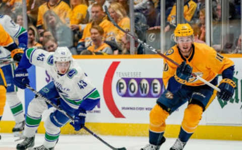 NASHVILLE, TN – APRIL 4: Colton Sissons #10 of the Nashville Predators skates against Quinn Hughes #43 of the Vancouver Canucks at Bridgestone Arena on April 4, 2019 in Nashville, Tennessee. (Photo by John Russell/NHLI via Getty Images)