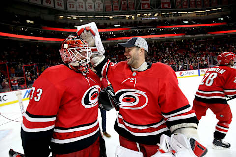 RALEIGH, NC – FEBRUARY 9: Cam Ward #30 of the Carolina Hurricanes congratulates teammate Scott Darling #33 on his win against the Vancouver Canucks following an NHL game on February 9, 2018 at PNC Arena in Raleigh, North Carolina. (Photo by Gregg Forwerck/NHLI via Getty Images)