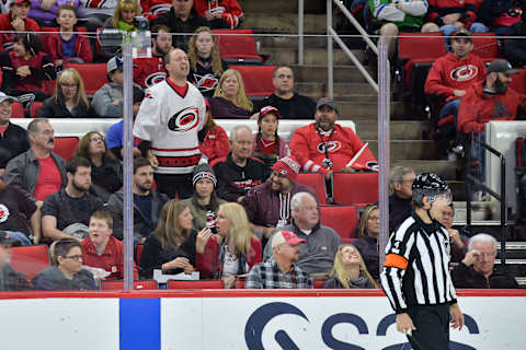 RALEIGH, NC – JANUARY 21: NHL referee Wes McCauley (4) gets berated by a fan during a game between the Vegas Golden Knights and the Carolina Hurricanes at the PNC Arena in Raleigh, NC on January 21, 2018. Vegas defeated Carolina 5-1. (Photo by Greg Thompson/Icon Sportswire via Getty Images)