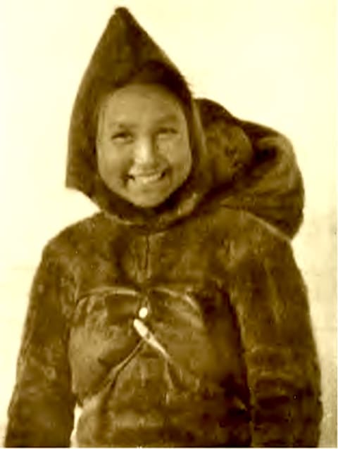 Akatingwah is photographed during Peary's 1905-1906 expedition, with her baby—possibly Anaukaq, her son with Matthew Henson—tucked into her hood.