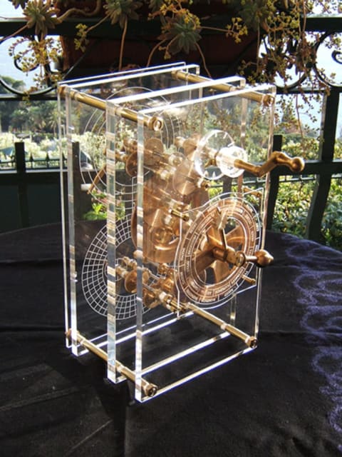 A 2007 reproduction of the mechanism shows the front panel at foreground.