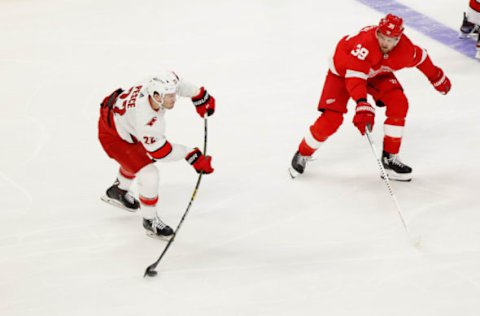 Jan 14, 2021; Detroit, Michigan, USA; Carolina Hurricanes defenseman Brett Pesce (22) takes a shot in the second period against the defended by Detroit Red Wings right wing Anthony Mantha (39) at Little Caesars Arena. Mandatory Credit: Rick Osentoski-USA TODAY Sports