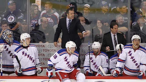 WINNIPEG, MB – DECEMBER 18: Alain Vigneault, head coach of the New York Rangers, stands on the bench to give directions in third period action in an NHL game against the Winnipeg Jets at the MTS Centre on December 18, 2015 in Winnipeg, Manitoba, Canada. (Photo by Marianne Helm/Getty Images)