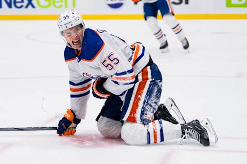 Oct 11, 2023; Vancouver, British Columbia, CAN; Edmonton Oilers forward Dylan Holloway (55) reacts after getting hit by a puck against the Vancouver Canucks in the third period at Rogers Arena. Vancouver won 8-1. Mandatory Credit: Bob Frid-USA TODAY Sports