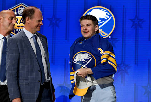 Jun 28, 2023; Nashville, Tennessee, USA; Buffalo Sabres draft pick Zach Benson puts on his sweater after being selected with the thirteenth pick in round one of the 2023 NHL Draft at Bridgestone Arena. Mandatory Credit: Christopher Hanewinckel-USA TODAY Sports