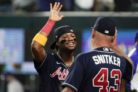 May 17, 2023; Arlington, Texas, USA; Atlanta Braves right fielder Ronald Acuna Jr. (13) high fives manager Brian Snitker (43) following a game against the Texas Rangers at Globe Life Field. Mandatory Credit: Raymond Carlin III-USA TODAY Sports