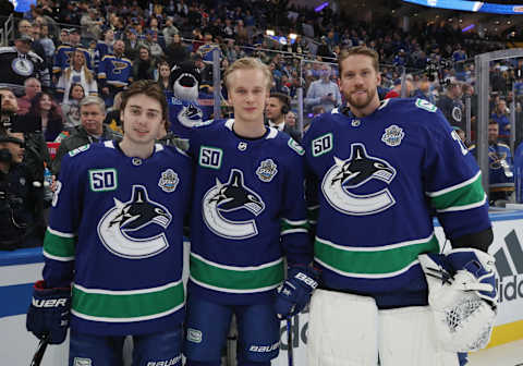 Quinn Hughes, Elias Pettersson, Jacob Markstrom of the Vancouver Canucks (Photo by Bruce Bennett/Getty Images)