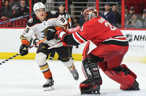 RALEIGH, NC – October 29: Carolina Hurricanes Goalie Scott Darling (33) shoves Anaheim Ducks Right Wing Jakob Silfverberg (33) in front of the crease during a game between the Anaheim Ducks and the Carolina Hurricanes at the PNC Arena in Raleigh, NC on October 29, 2017. Anaheim defeated Carolina 4-3 in a shootout. (Photo by Greg Thompson/Icon Sportswire via Getty Images)