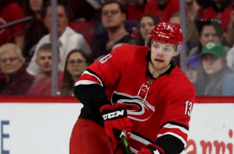 RALEIGH, NC – APRIL 4: Warren Foegele #13 of the Carolina Hurricanes moves the puck against the New Jersey Devils during an NHL game at PNC Arena on April 4, 2019, in Raleigh, North Carolina. (Photo by Gregg Forwerck/NHLI via Getty Images)