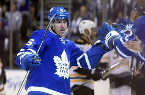 Oct 15, 2016; Toronto, Ontario, CAN; Toronto Maple Leafs forward Mitch Marner (16) celebrates with teammates after scoring his first career NHL goal against Boston Bruins in the first period at Air Canada Centre. Mandatory Credit: Dan Hamilton-USA TODAY Sports