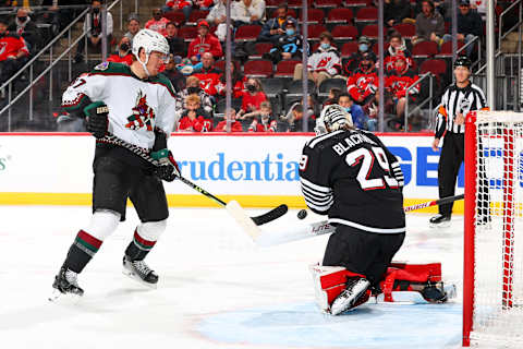 Lawson Crouse attempts a shot in close against Mackenzie Blackwood. (Photo by Rich Graessle/Getty Images)