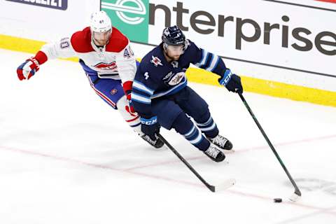 Jun 2, 2021; Winnipeg, Manitoba, CAN; Montreal Canadiens Joel Armia chases Neal Pionk. Mandatory Credit: James Carey Lauder-USA TODAY Sports