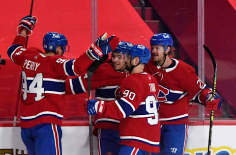 May 24, 2021; Montreal, Quebec, CAN; Montreal Canadiens forward Nick Suzuki (14) reacts with teammates including forward Corey Perry (94) and forward Tomas Tatar (90) after scoring a goal against the Toronto Maple Leafs during the second period in game three of the first round of the 2021 Stanley Cup Playoffs at the Bell Centre. Mandatory Credit: Eric Bolte-USA TODAY Sports