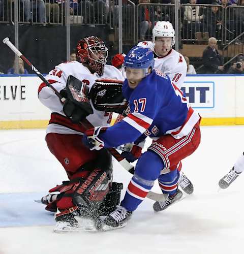 NEW YORK, NEW YORK – NOVEMBER 27: Jesper Fast #17 of the New York Rangers attempts to avoid contact with Petr Mrazek #34 of the Carolina Hurricanes during the second period at Madison Square Garden on November 27, 2019 in New York City. The Rangers defeated the Hurricanes 3-2. (Photo by Bruce Bennett/Getty Images)