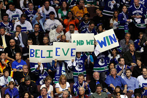 A fan of the Vancouver Canucks holds up a sign (Photo by Rich Lam/Getty Images)