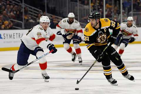 Apr 26, 2022; Boston, Massachusetts, USA; Boston Bruins center Patrice Bergeron (37) carries the puck past Florida Panthers defenseman Robert Hagg (18) during the first period at TD Garden. Mandatory Credit: Winslow Townson-USA TODAY Sports