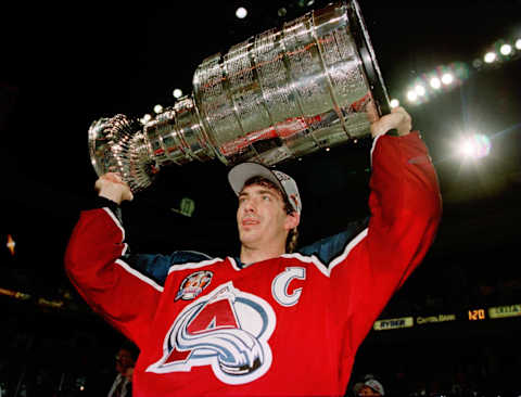 11 Jun 1996: Joe Sakic, captain of the Colorado Avalanche carries the Stanley Cup trophy after defeating the Florida Panthers 1-0 in triple overtime of game four of the Stanley Cup Finals at Miami Arena in Miami, Florida. Sakic was awarded the Conn Smythe