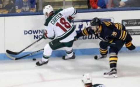 Sep 26, 2016; State College, PA, USA; Buffalo Sabres forward Zemgus Girgensons (28) and Minnesota Wild forward Ryan Carter (18) battle for the puck during the third period during a preseason hockey game at Pegula Ice Arena. The Wild defeated the Sabres 2-1. Mandatory Credit: Matthew O