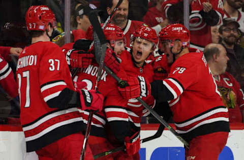 RALEIGH, NC – NOVEMBER 12: Carolina Hurricanes teammates Carolina Hurricanes Right Wing Andrei Svechnikov (37), Carolina Hurricanes Left Wing Jordan Martinook (48), Carolina Hurricanes Left Wing Micheal Ferland (79) mob Carolina Hurricanes Center Sebastian Aho (20) after scoring the game winning goal in overtime during a game between the Chicago Blackhawks and the Carolina Hurricanes at the PNC Arena in Raleigh, NC on November 12, 2018. (Photo by Greg Thompson/Icon Sportswire via Getty Images)