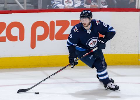 WINNIPEG, MB – MAY 20: Jacob Trouba #8 of the Winnipeg Jets plays the puck down the ice during second period action against the Vegas Golden Knights in Game Five of the Western Conference Final during the 2018 NHL Stanley Cup Playoffs at the Bell MTS Place on May 20, 2018 in Winnipeg, Manitoba, Canada. The Knights defeated the Jets 2-1 and win the series 4-1. (Photo by Jonathan Kozub/NHLI via Getty Images)