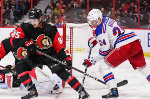 OTTAWA, CANADA – NOVEMBER 30: Jake Sanderson #85 of the Ottawa Senators battles for the puck with Kaapo Kakko #24 of the New York Rangers at Canadian Tire Centre on November 30, 2022, in Ottawa, Ontario, Canada. (Photo by Chris Tanouye/Freestyle Photography/Getty Images)