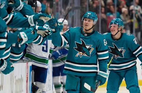 Nov 25, 2023; San Jose, California, USA; San Jose Sharks center Mikael Granlund (64) and left-wing Fabian Zetterlund (20) shake hands with their teammates on the bench after Granlund scored a goal against the Vancouver Canucks during the third period at SAP Center at San Jose. Mandatory Credit: Robert Edwards-USA TODAY Sports