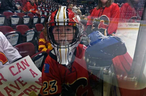 CALGARY, AB – DECEMBER 16: A young fan waits for an NHL game to begin betwen the Nashville Predators and the Calgary Flames on December 16, 2017 at the Scotiabank Saddledome in Calgary, Alberta, Canada. (Photo by Terence Leung/NHLI via Getty Images)