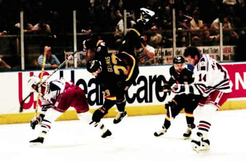 Rangers Craig MacTavish (14) sends Vancouver’s Martin Gelinas (23) flying during game 7 of the Stanley Cup finals at Madison Square Garden June 14, 1994. The Rangers won the game 3-2 and the Stanley Cup.Rangers Win Stanley Cup