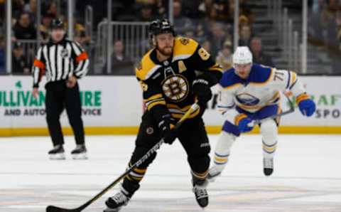 David Pastrnak (center) prepares to shoot the puck in a game vs. the Buffalo Sabres at the TD Garden.